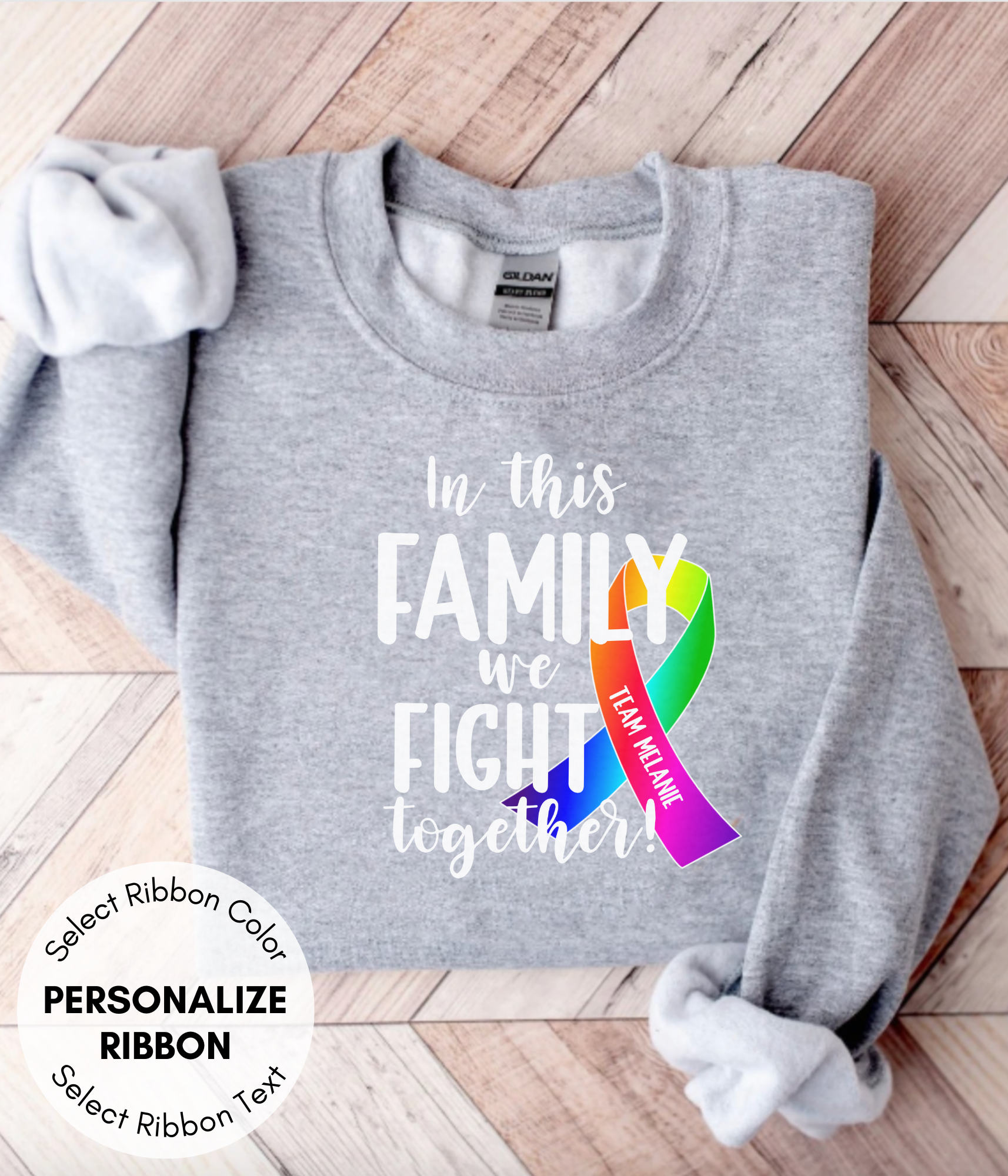 a gray shirt with a rainbow ribbon on it