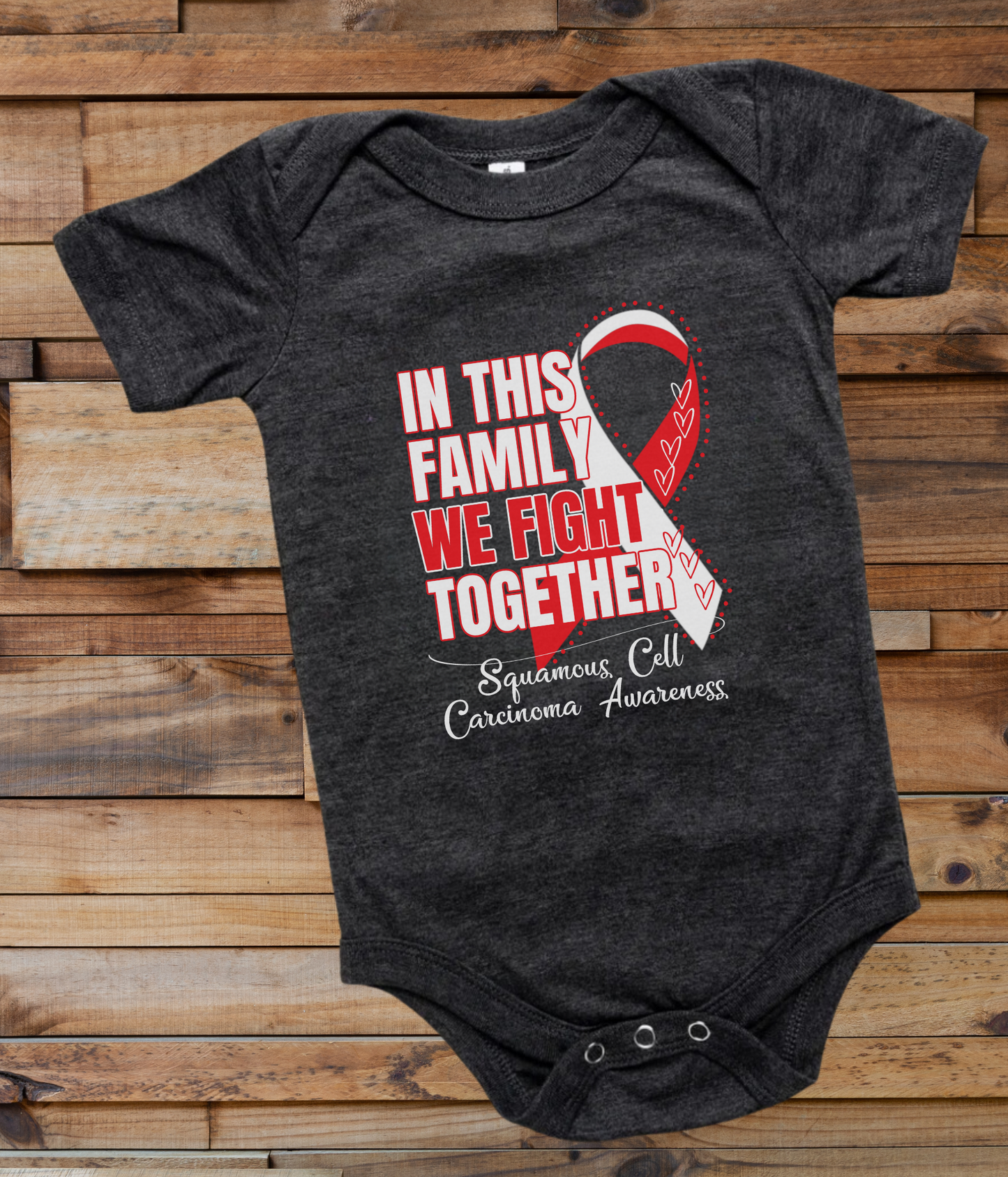 a black onesuit with a red ribbon in this family we fight together