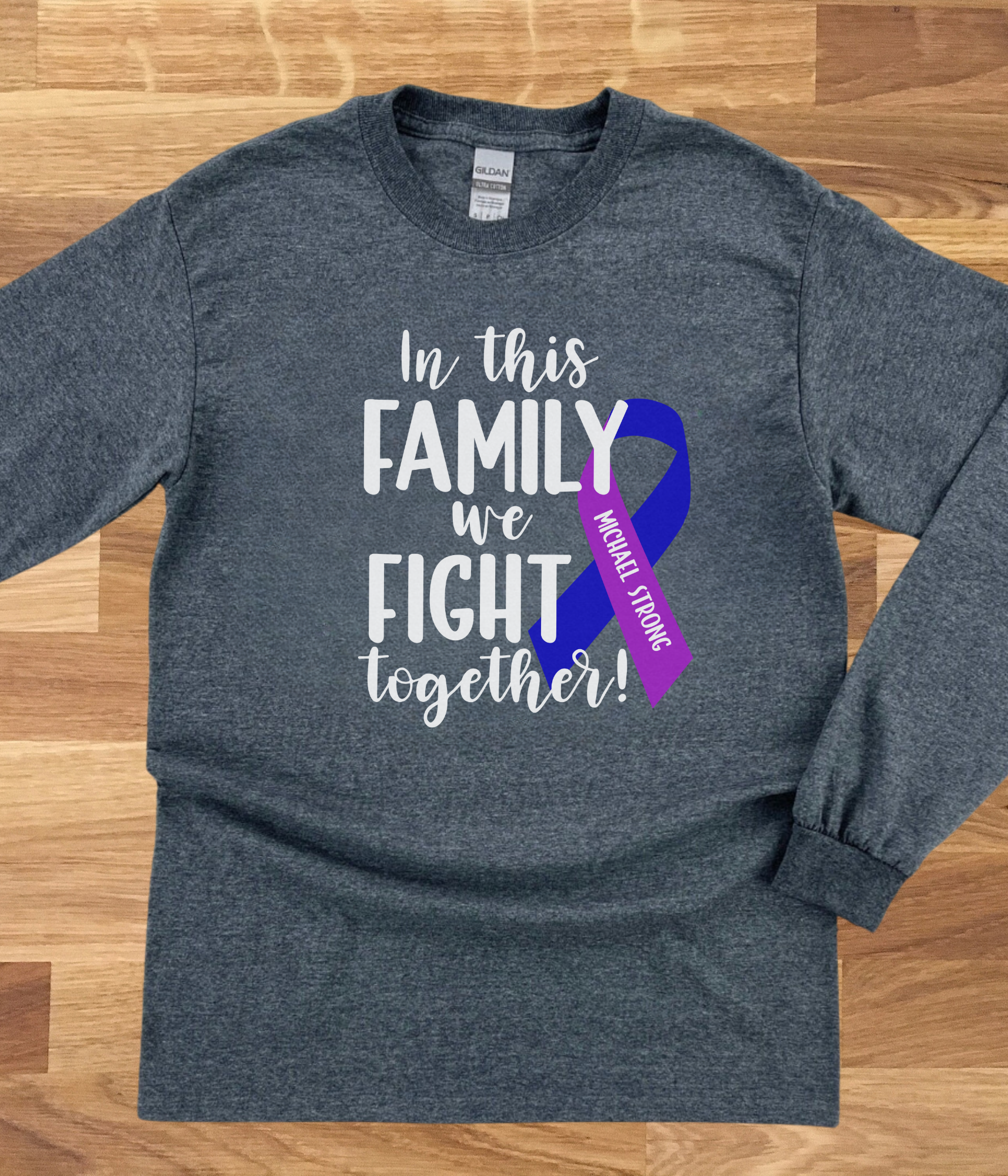 a gray shirt with a purple ribbon on it