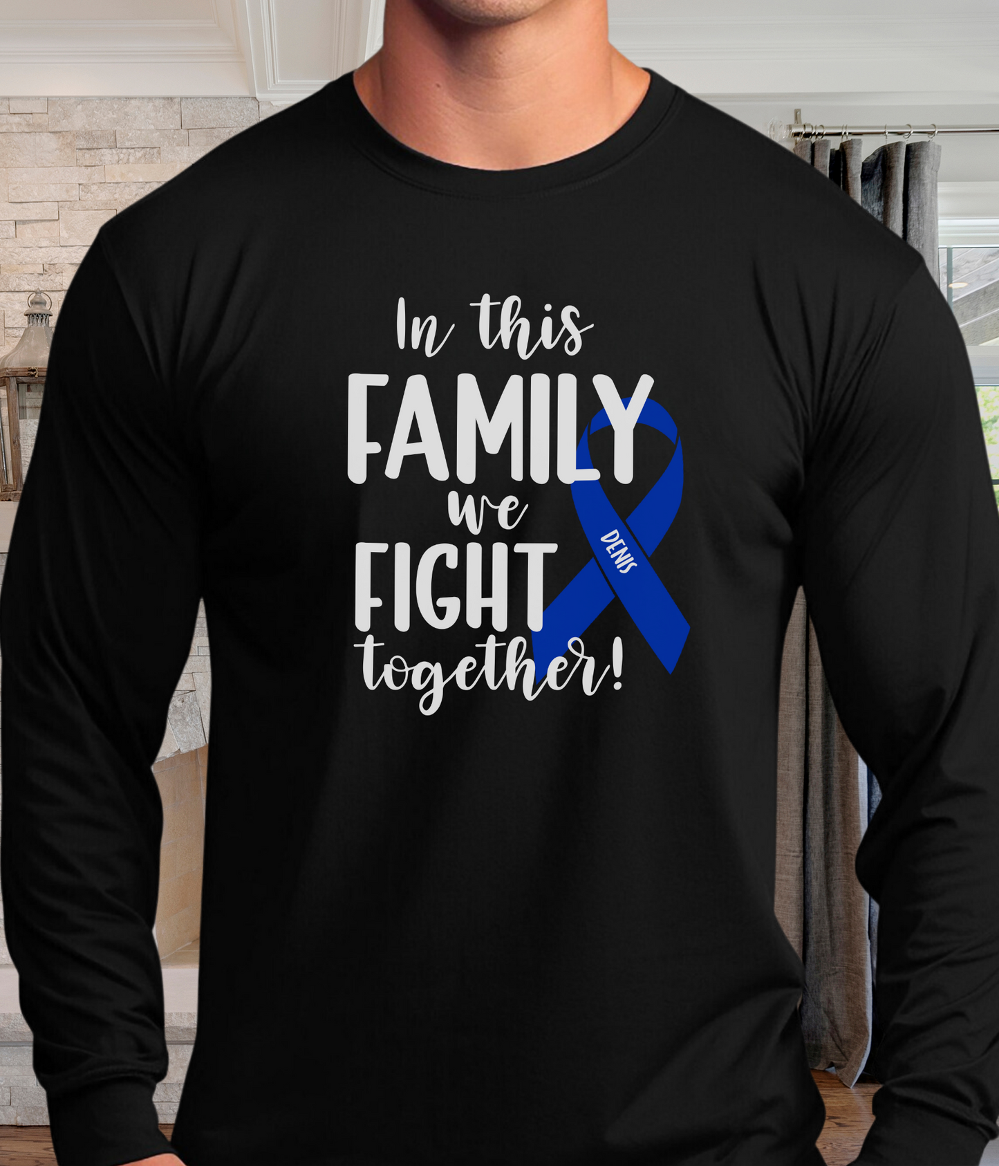 a man wearing a black shirt with a blue ribbon on it