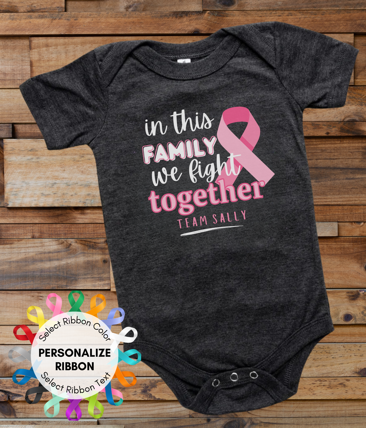 a black onesuit with a pink ribbon in this family we fight together