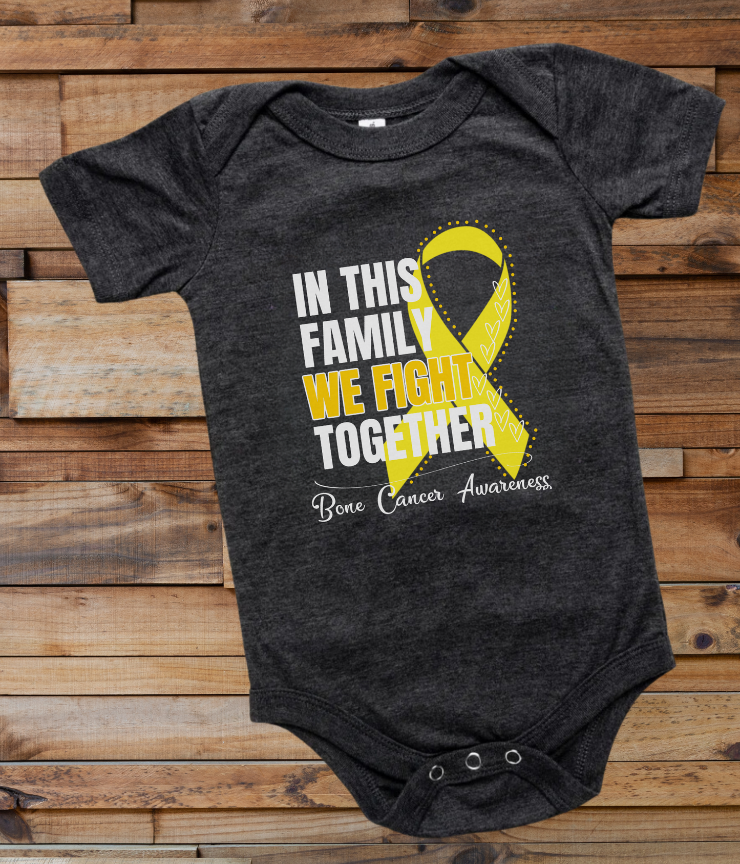 a black onesuit with a yellow ribbon in this family we fight together