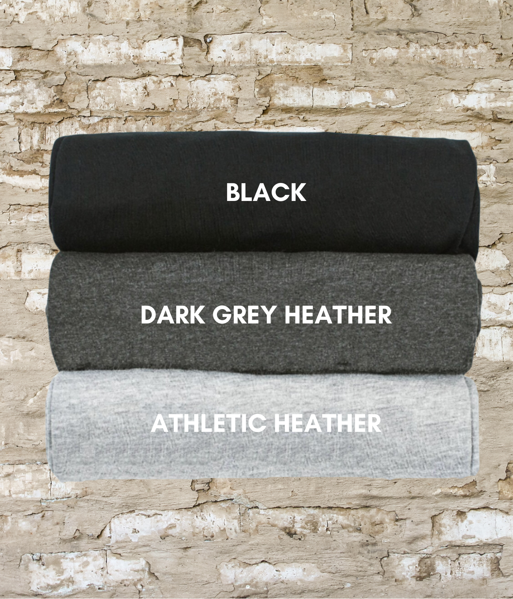 three black, dark grey, and white blankets on a brick wall