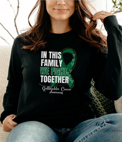 a woman sitting on a couch wearing a black shirt with a green ribbon