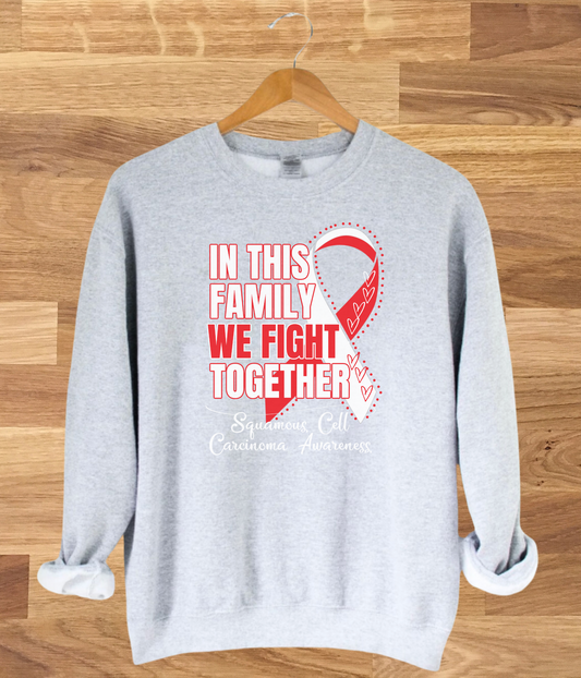 a grey sweatshirt with a red ribbon on it