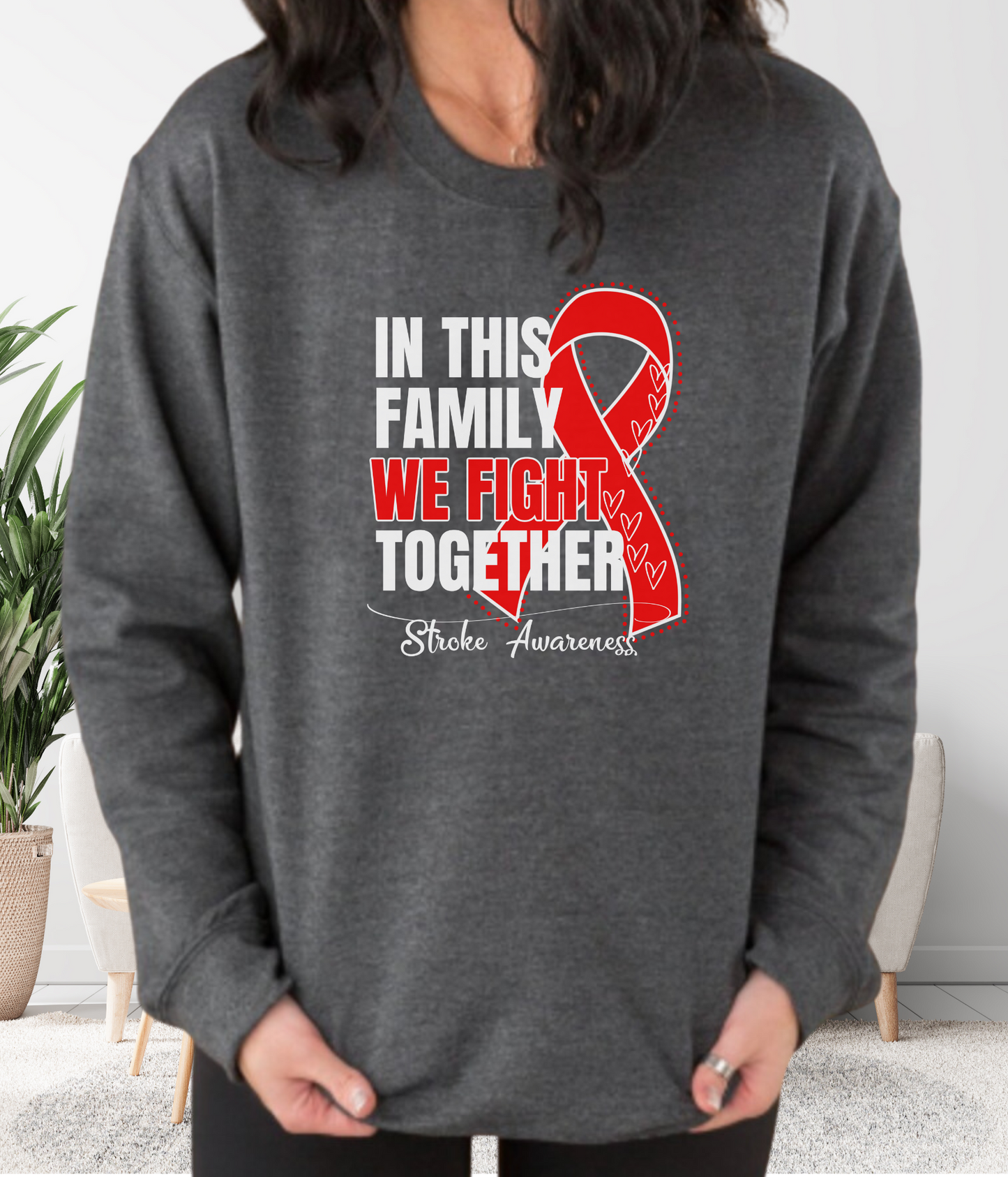 a woman wearing a sweatshirt that says in this family we fight together