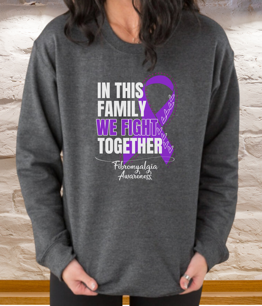 a woman wearing a sweatshirt that says in this family we fight together