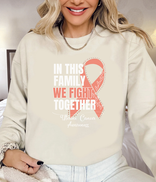 a woman wearing a sweatshirt with a pink ribbon on it