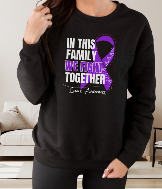 a woman wearing a black sweatshirt with a purple ribbon on it