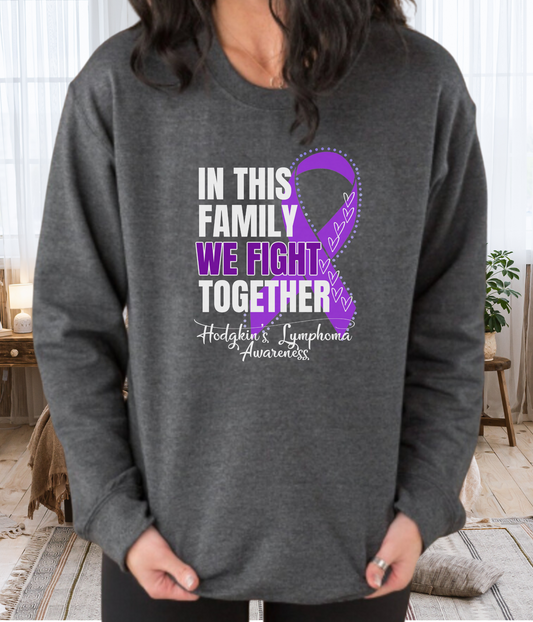 a woman wearing a sweatshirt that says in this family we fight together