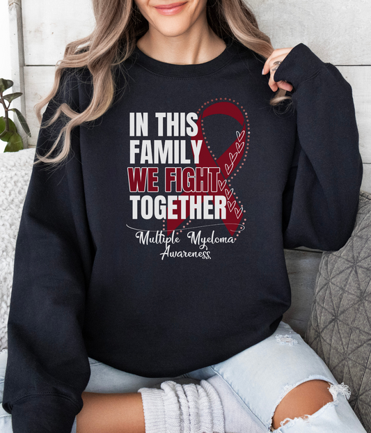 a woman wearing a sweatshirt that says in this family we fight together