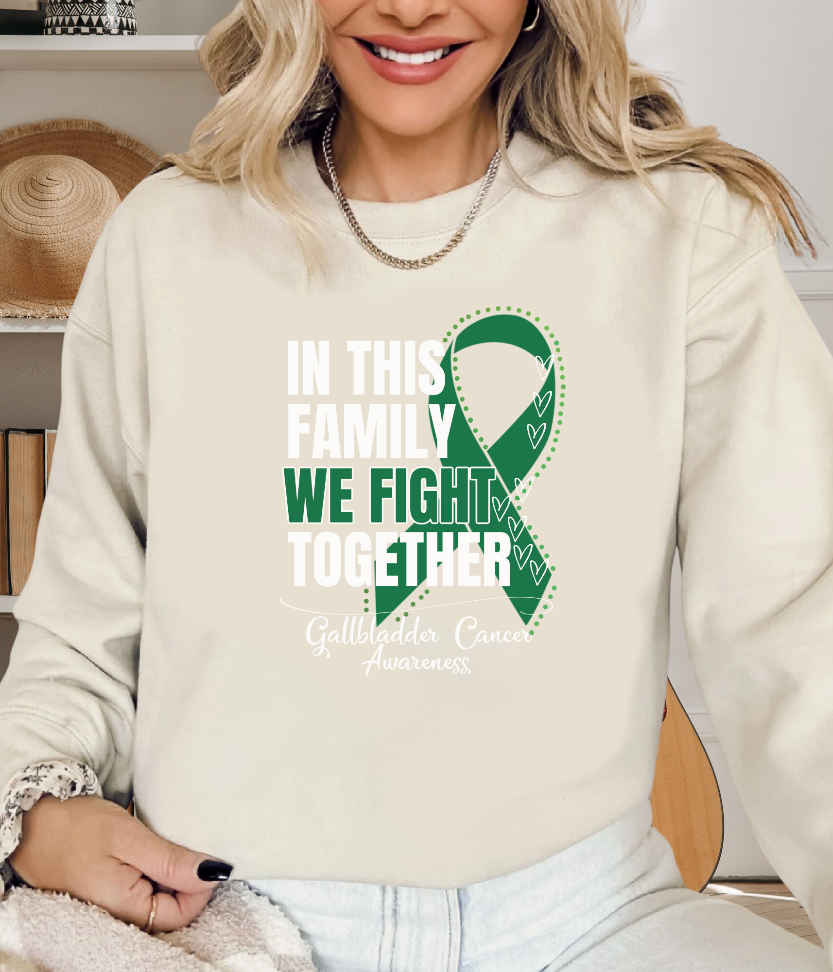 a woman wearing a sweatshirt with a green ribbon on it