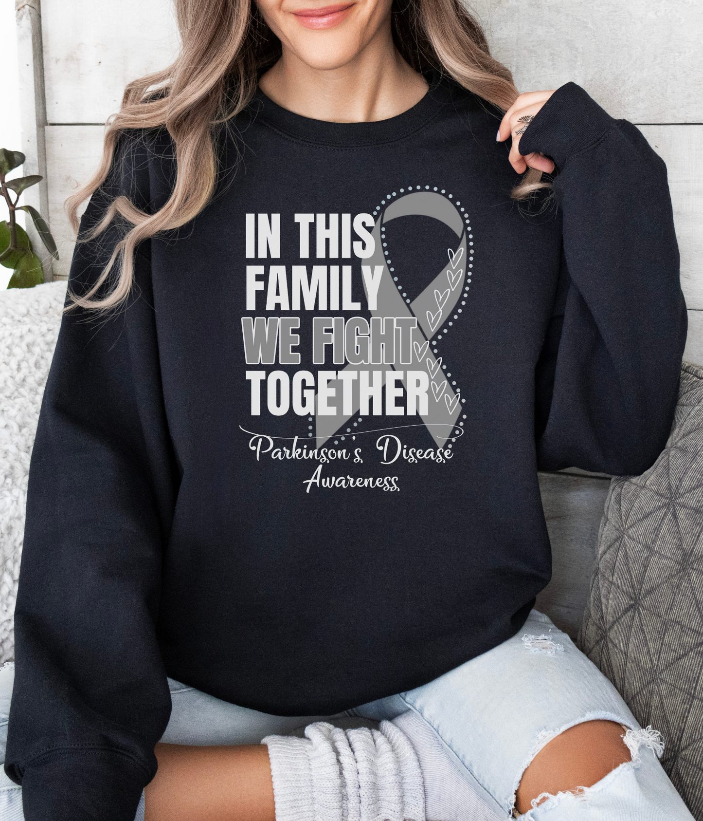 a woman wearing a black sweatshirt that says in this family we fight together