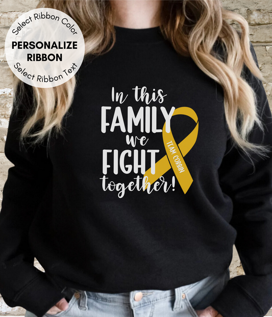 a woman wearing a black sweater with a yellow ribbon on it