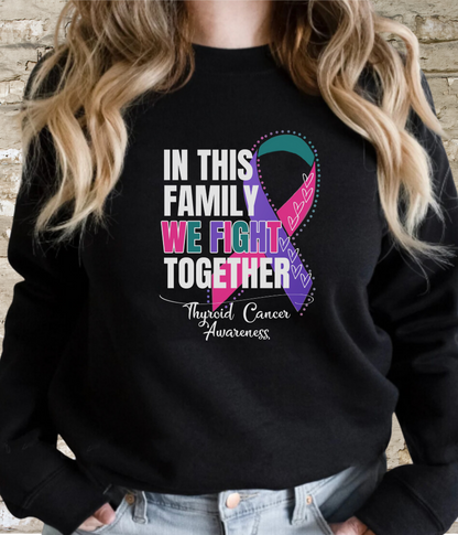 a woman wearing a black sweatshirt with a colorful ribbon on it