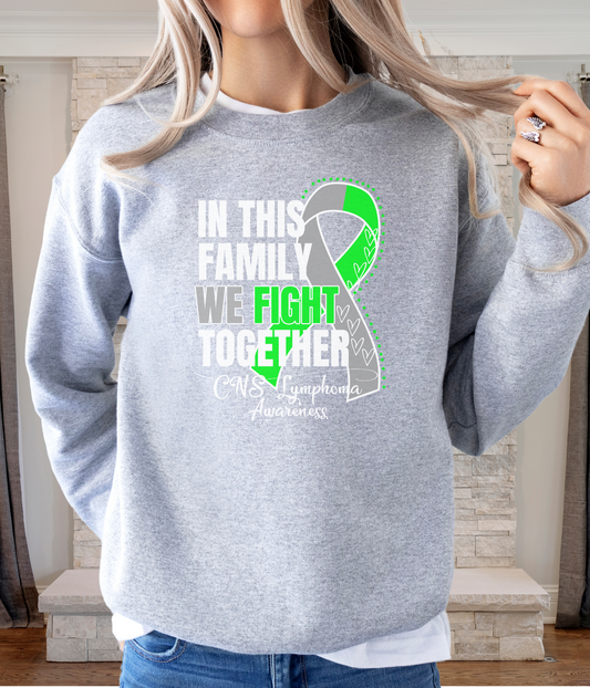 a woman wearing a sweatshirt with a green ribbon on it