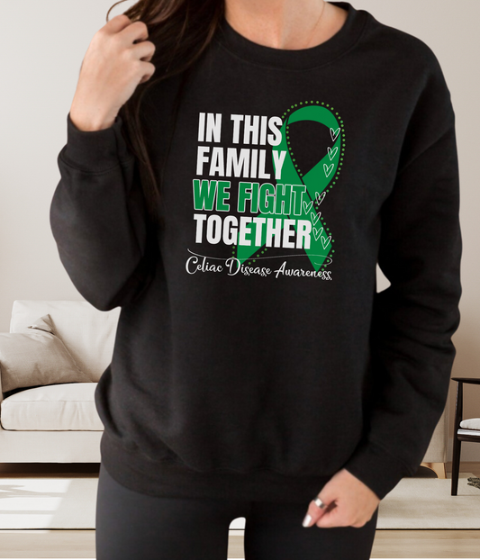 a woman wearing a black sweatshirt with a green ribbon on it