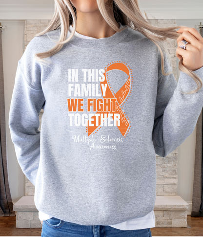 a woman wearing a sweatshirt with an orange ribbon on it