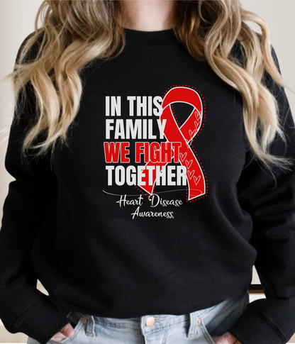 a woman wearing a black sweater with a red ribbon on it