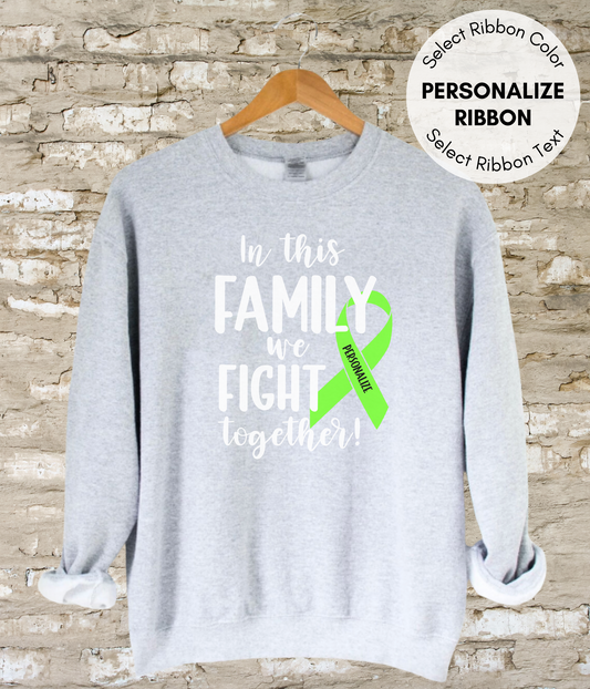 a gray sweatshirt with a green ribbon on it