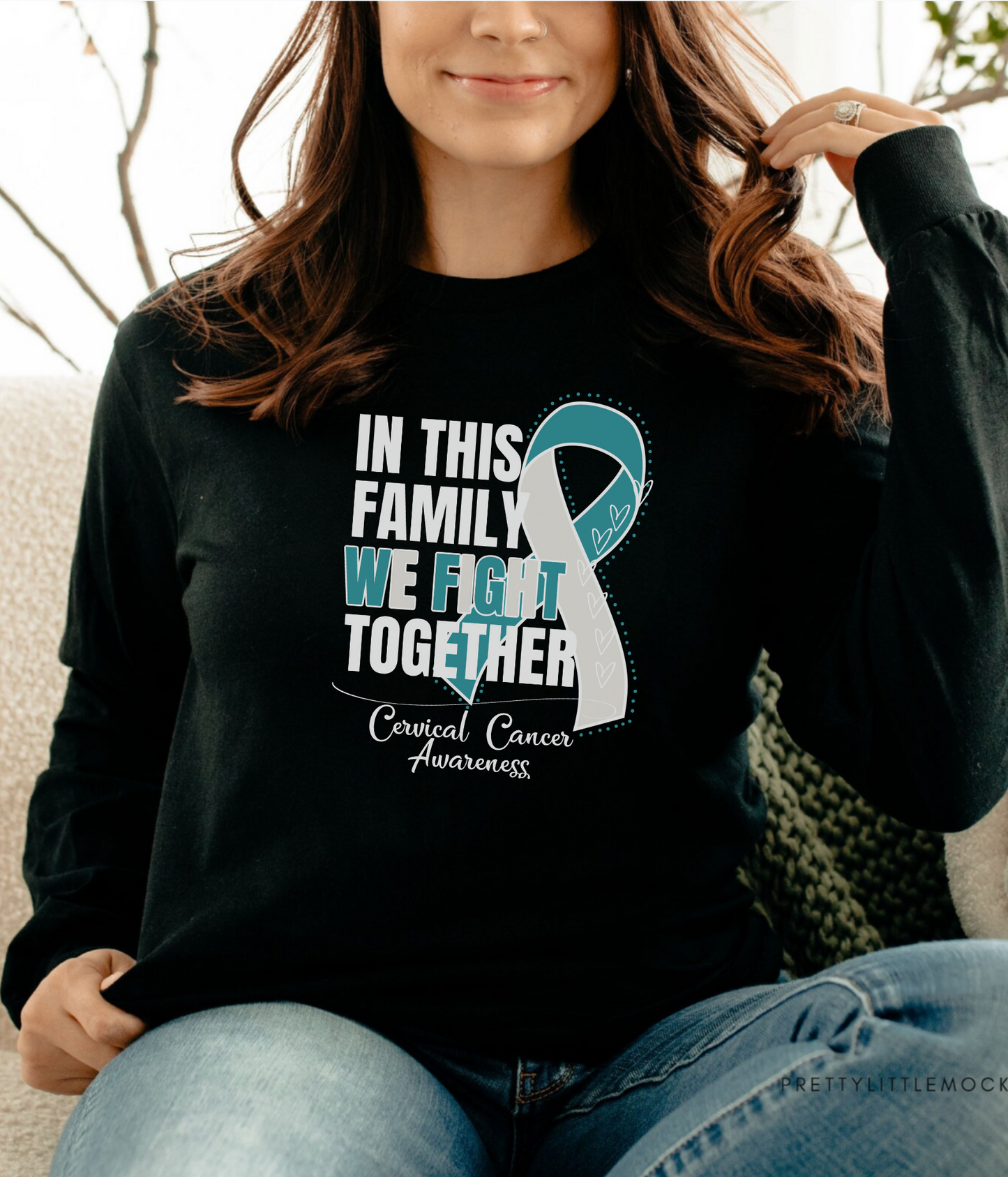 a woman sitting on a couch wearing a black shirt