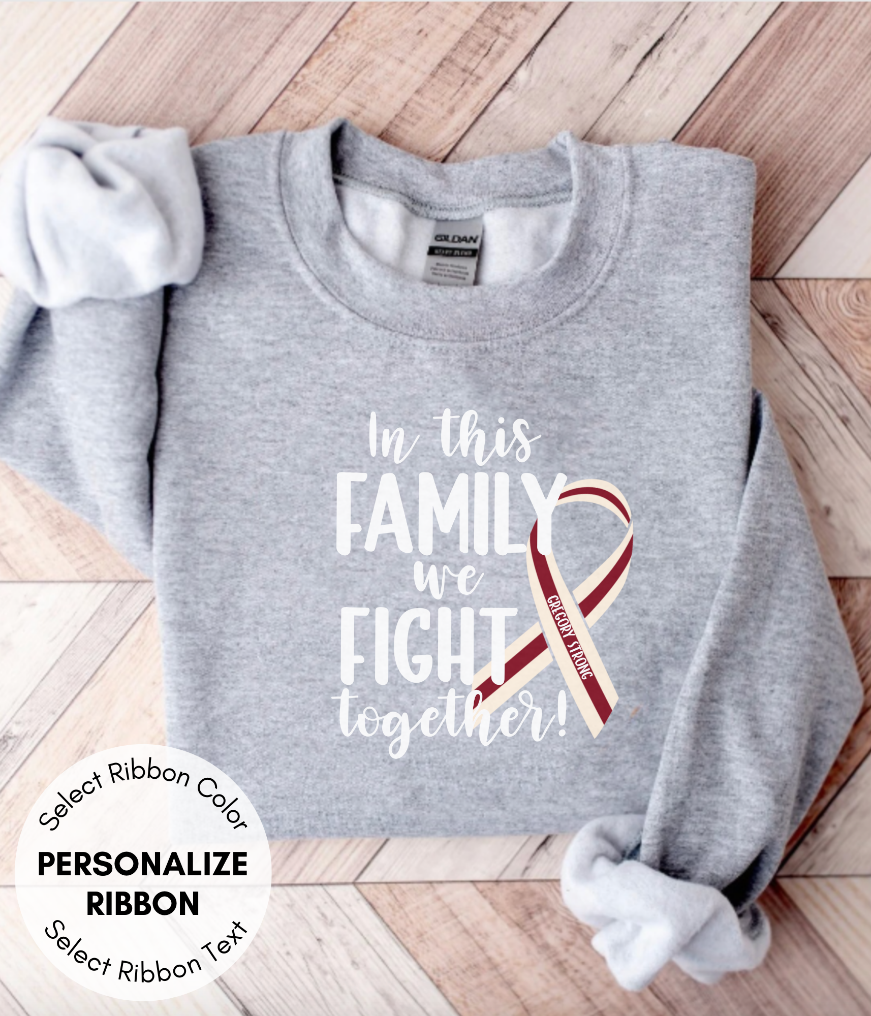 a gray shirt with a red ribbon on it that says in this family we fight