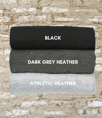 three black, dark grey, and white blankets on a brick wall