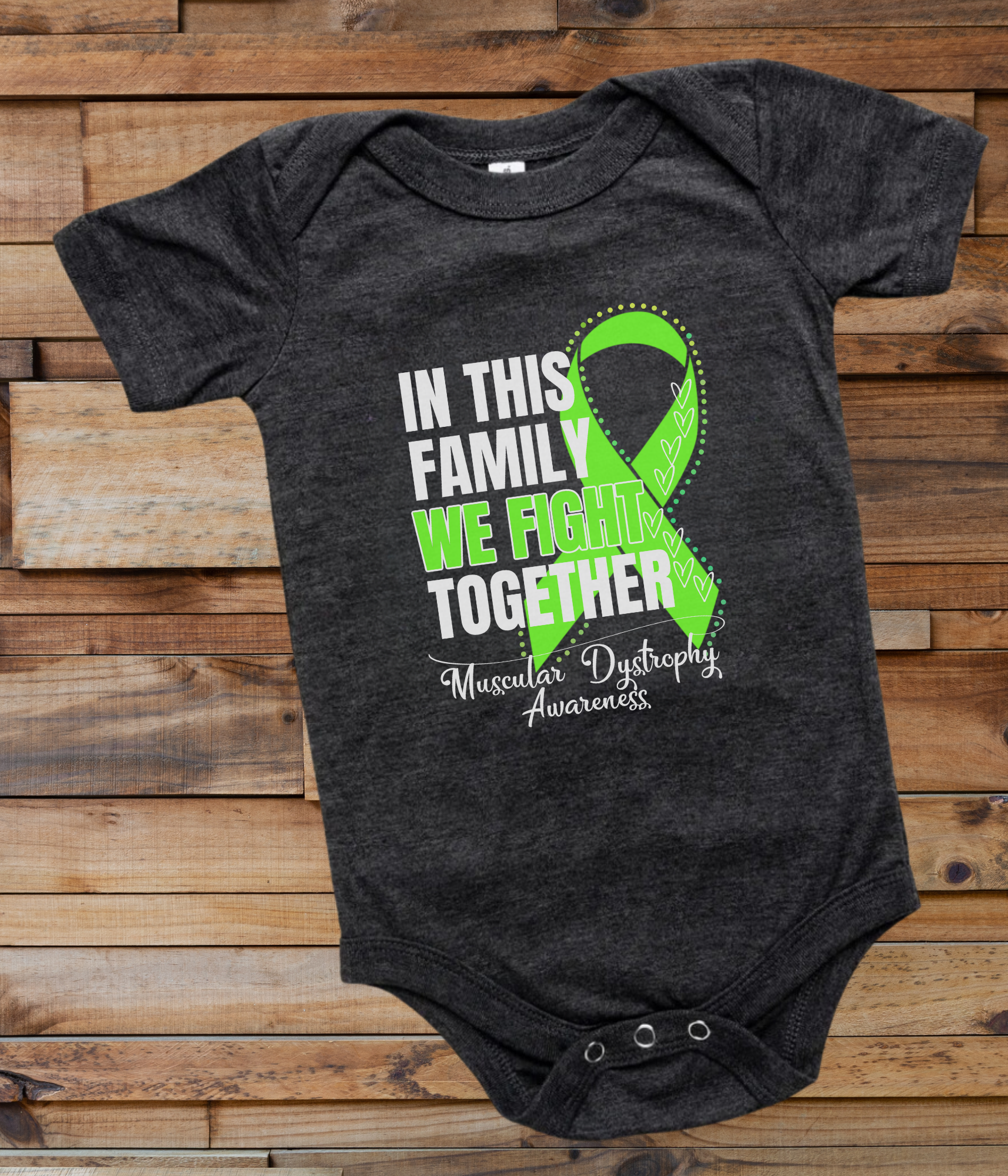 a black onesuit with a green ribbon in this family we fight together