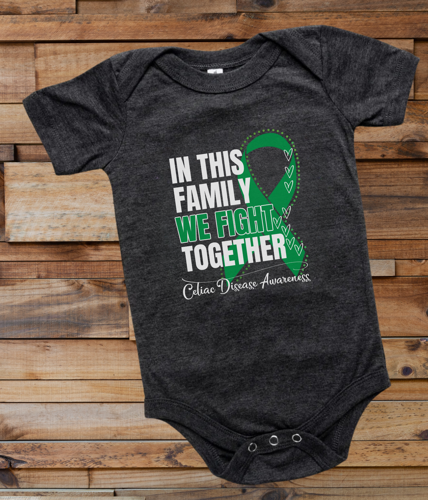 a black onesuit with a green ribbon in this family we fight together