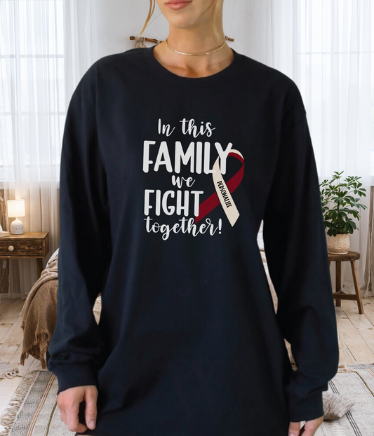 a woman wearing a black shirt that says in this family we fight together