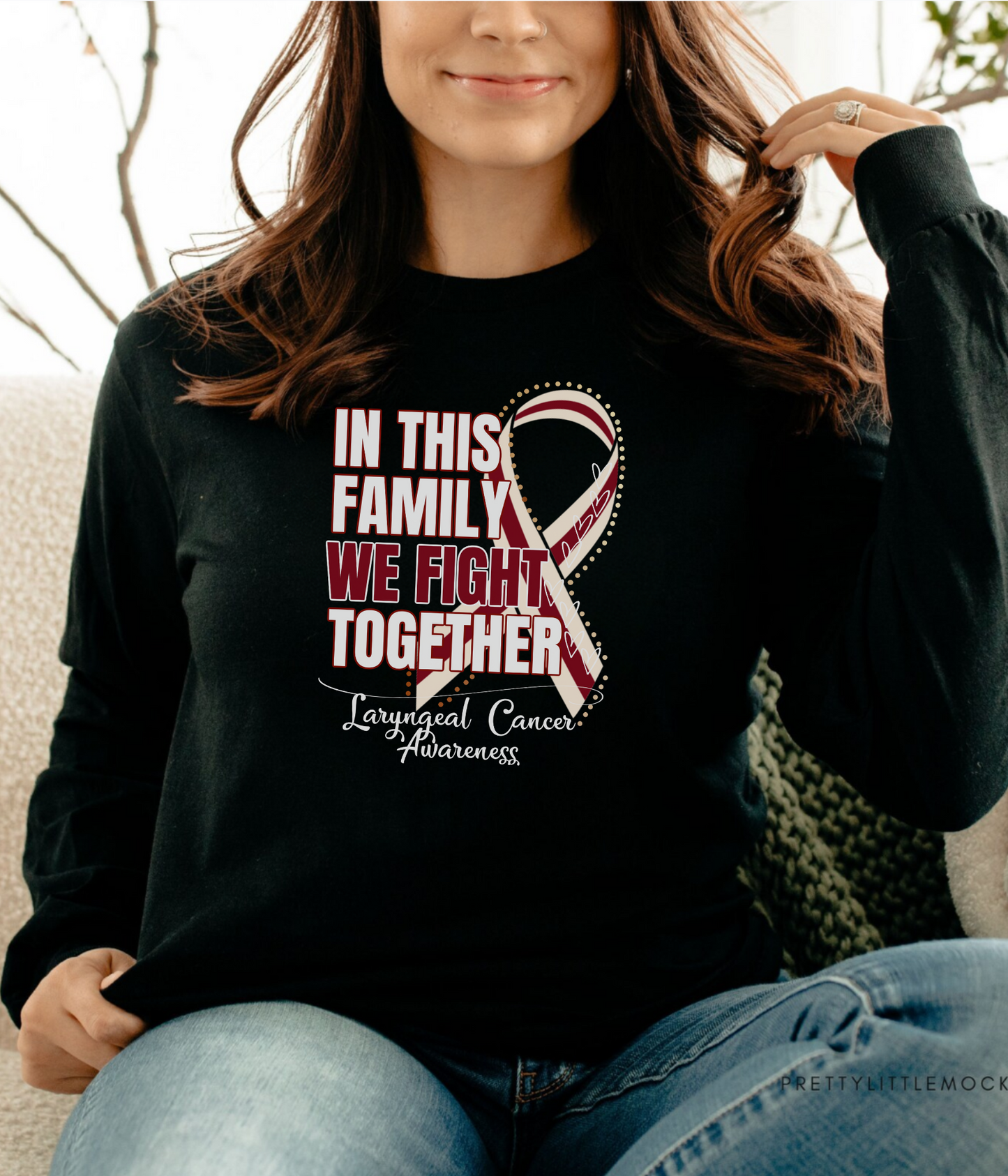 a woman sitting on a couch wearing a black shirt