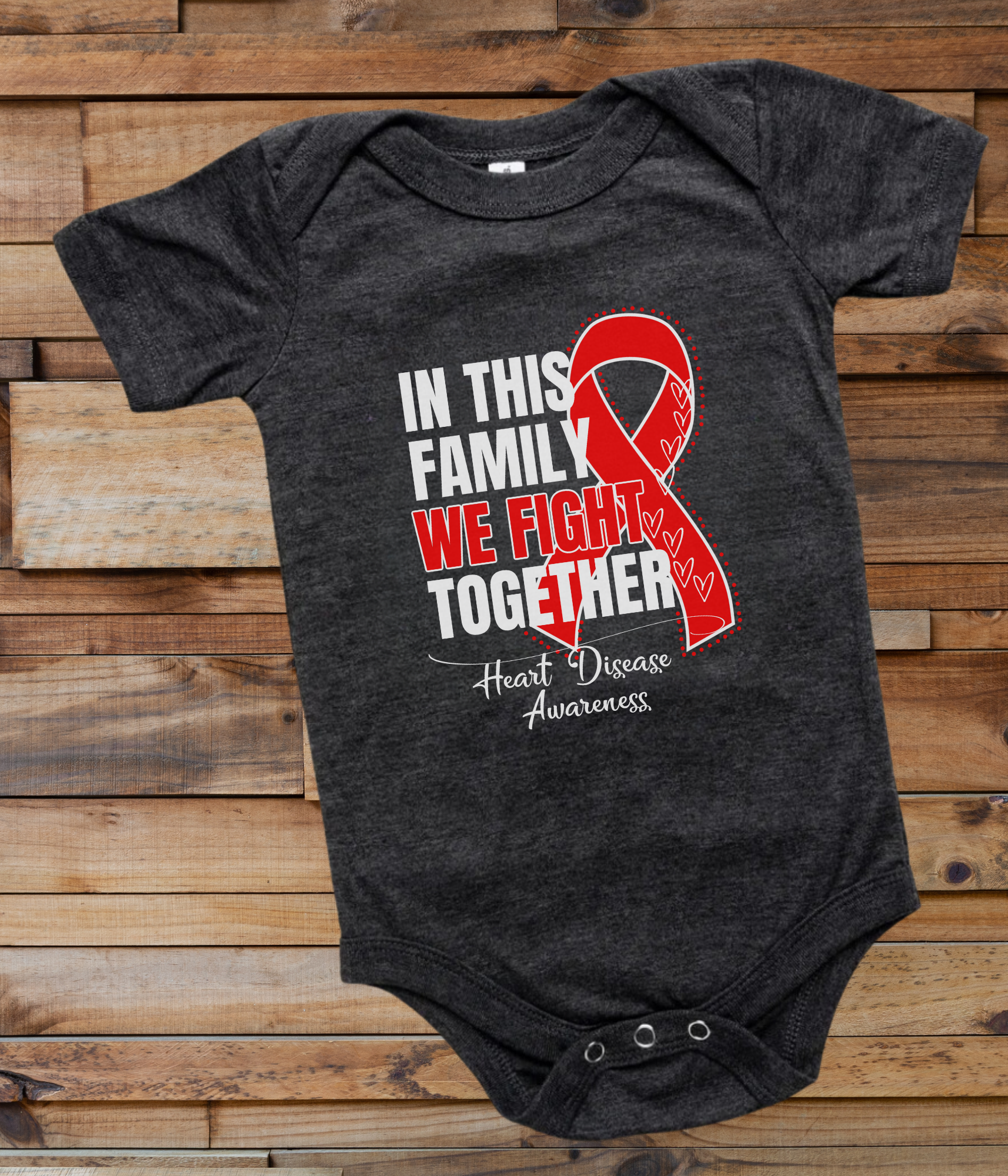 a black onesuit with a red ribbon in this family we fight together