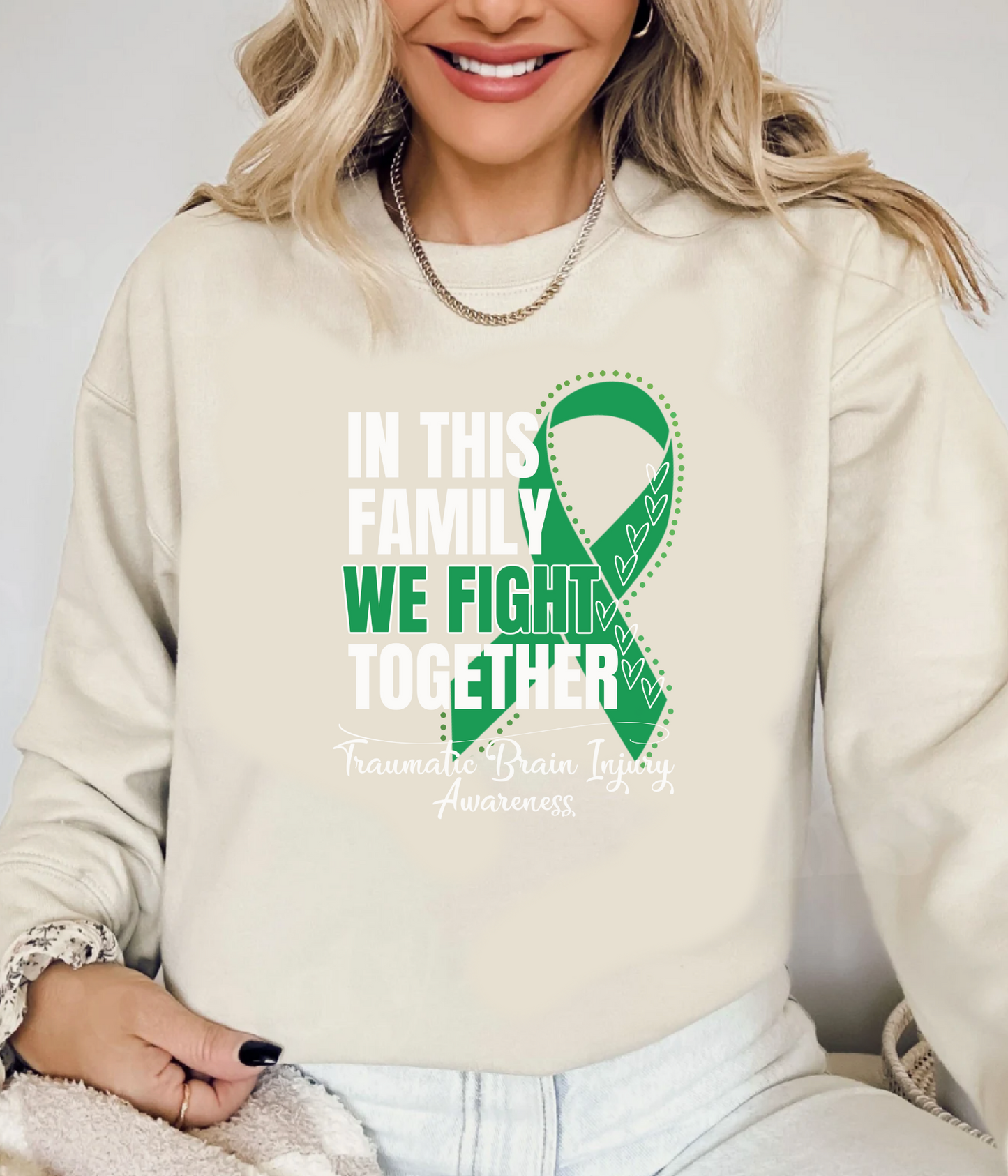 a woman wearing a sweatshirt that says in this family we fight together