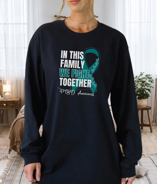 a woman wearing a t - shirt that says in this family we fight together