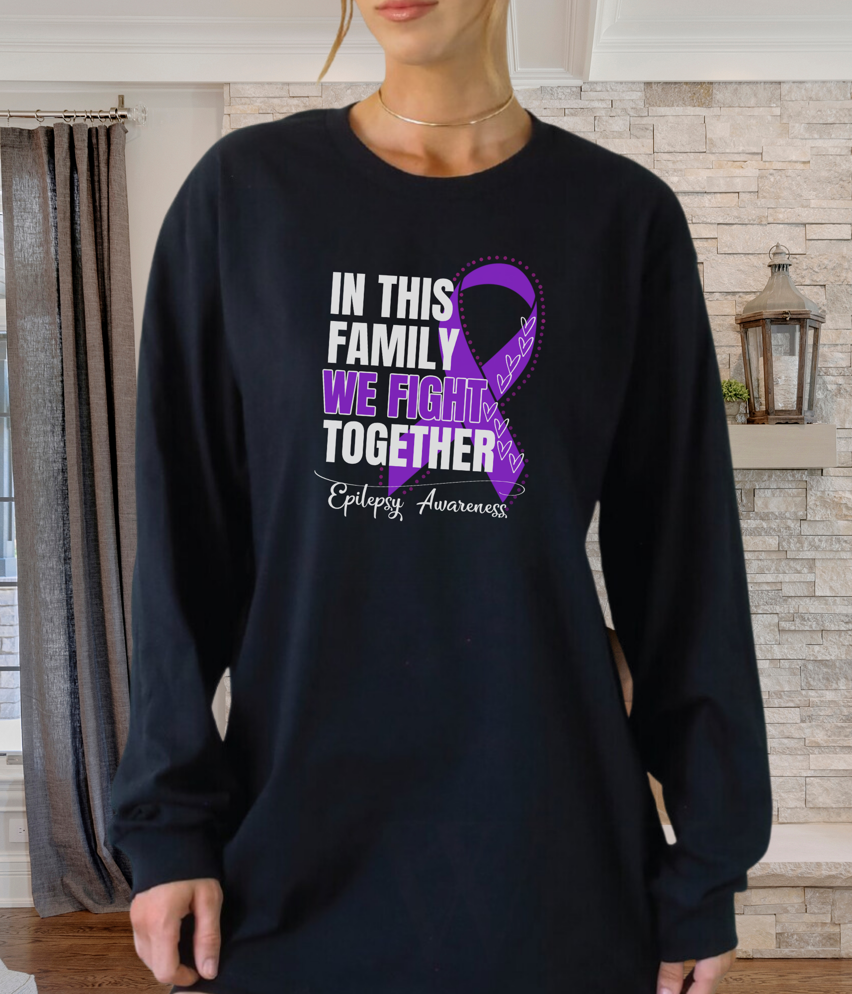 a woman wearing a black shirt with a purple ribbon on it