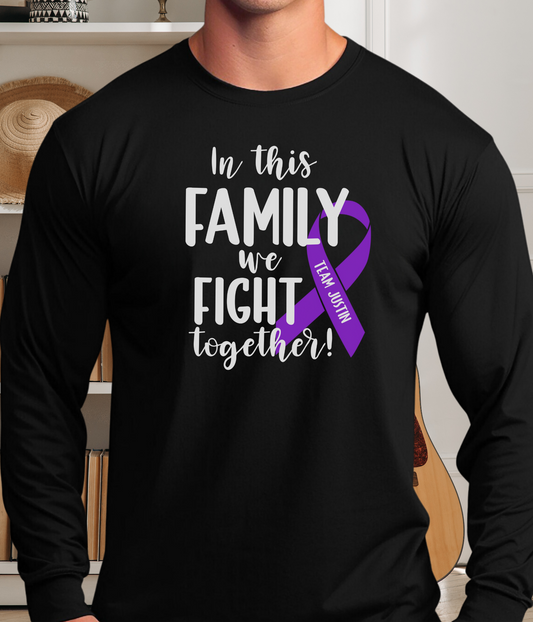 a man wearing a black shirt with a purple ribbon on it