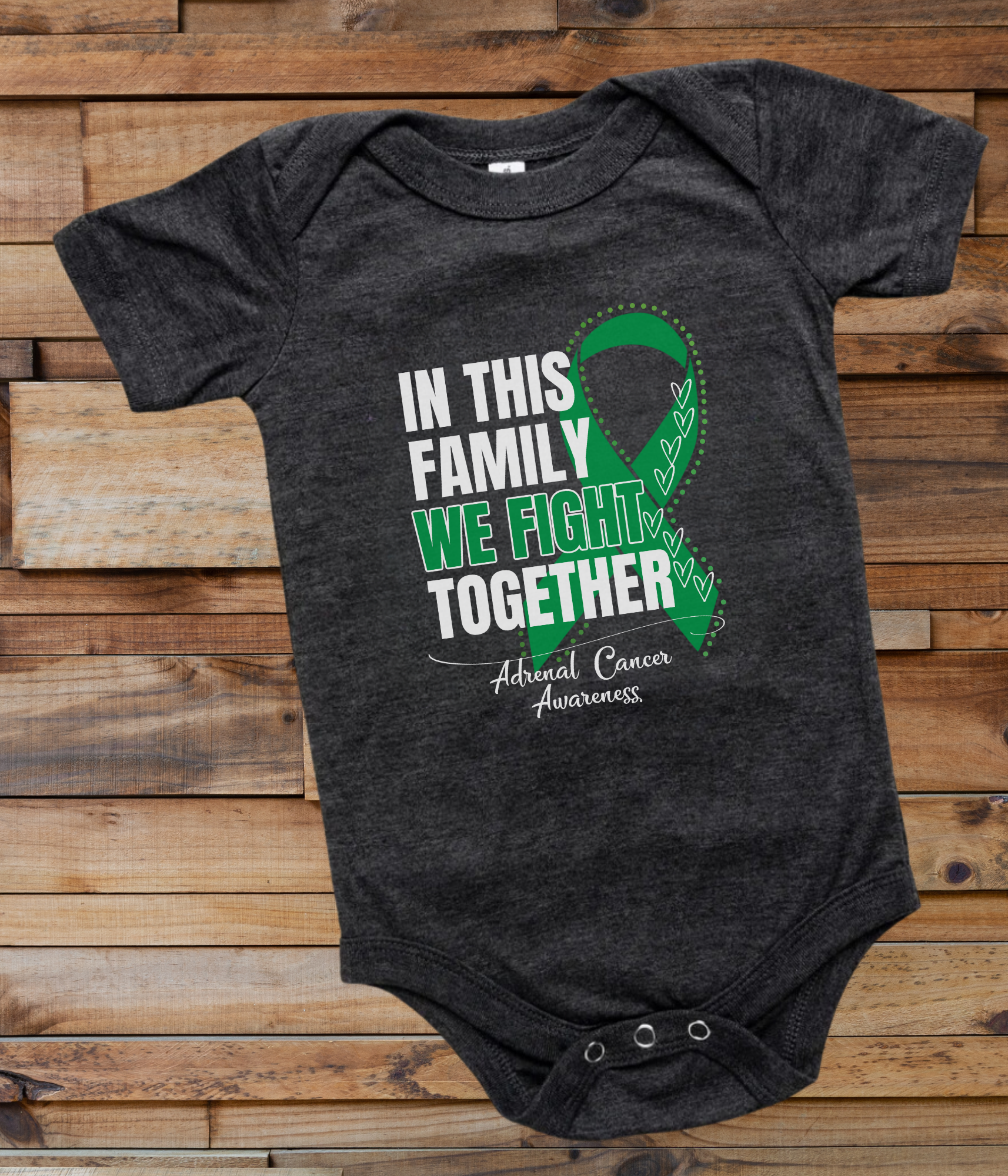 a black onesuit with a green ribbon in this family we fight together