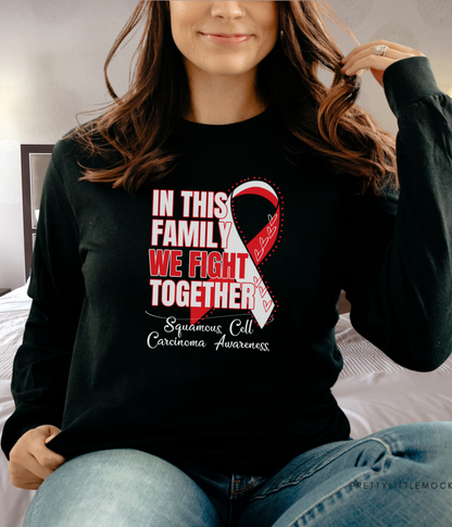 a woman wearing a black shirt with a red ribbon on it