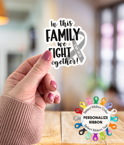 a person holding up a sticker that says in this family we fight together