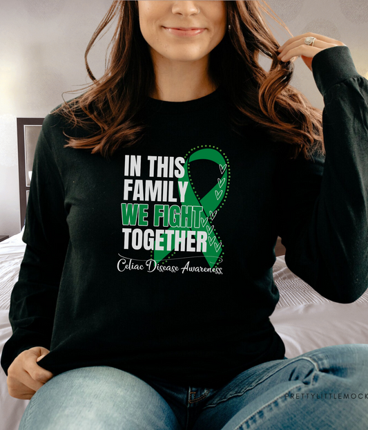 a woman wearing a black shirt with a green ribbon on it
