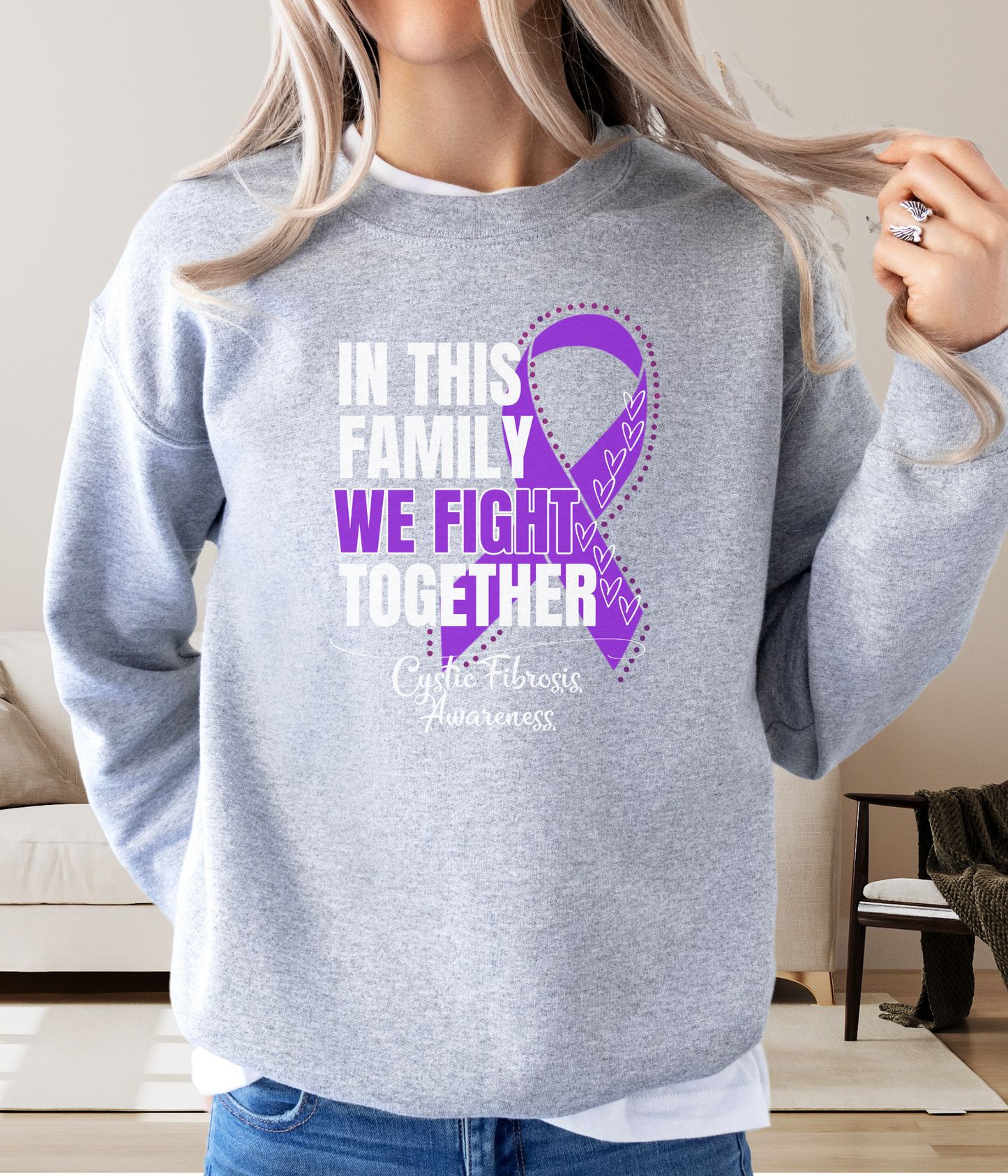 a woman wearing a sweatshirt that says in this family we fight together