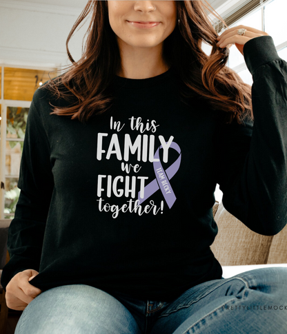 a woman sitting on a couch wearing a t - shirt that says in this family