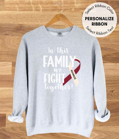 a grey sweatshirt with a red ribbon on it