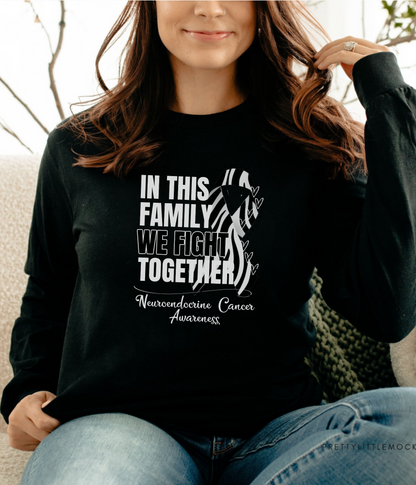 a woman sitting on a couch wearing a black shirt