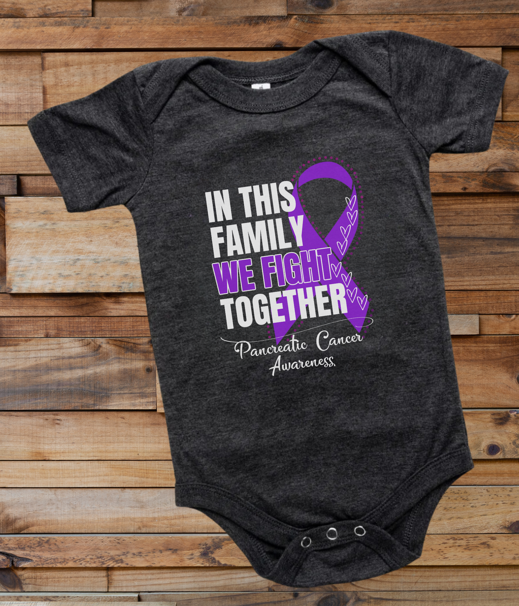 a black onesuit with a purple ribbon in this family we fight together