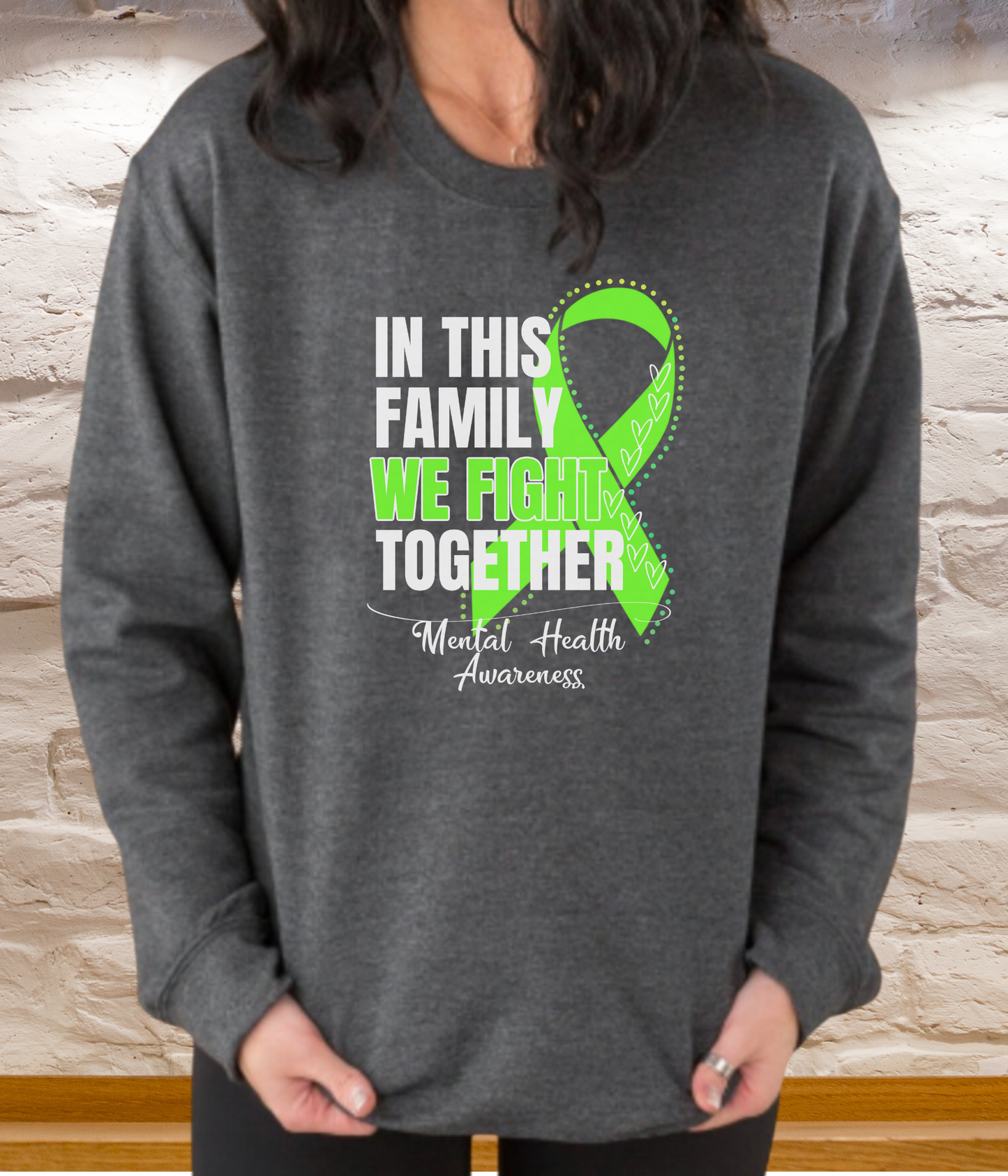 a woman wearing a sweatshirt that says in this family we fight together