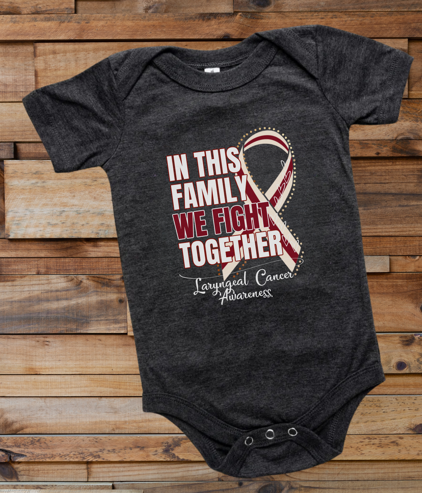 a black onesuit with a red and white ribbon in this family we fight together