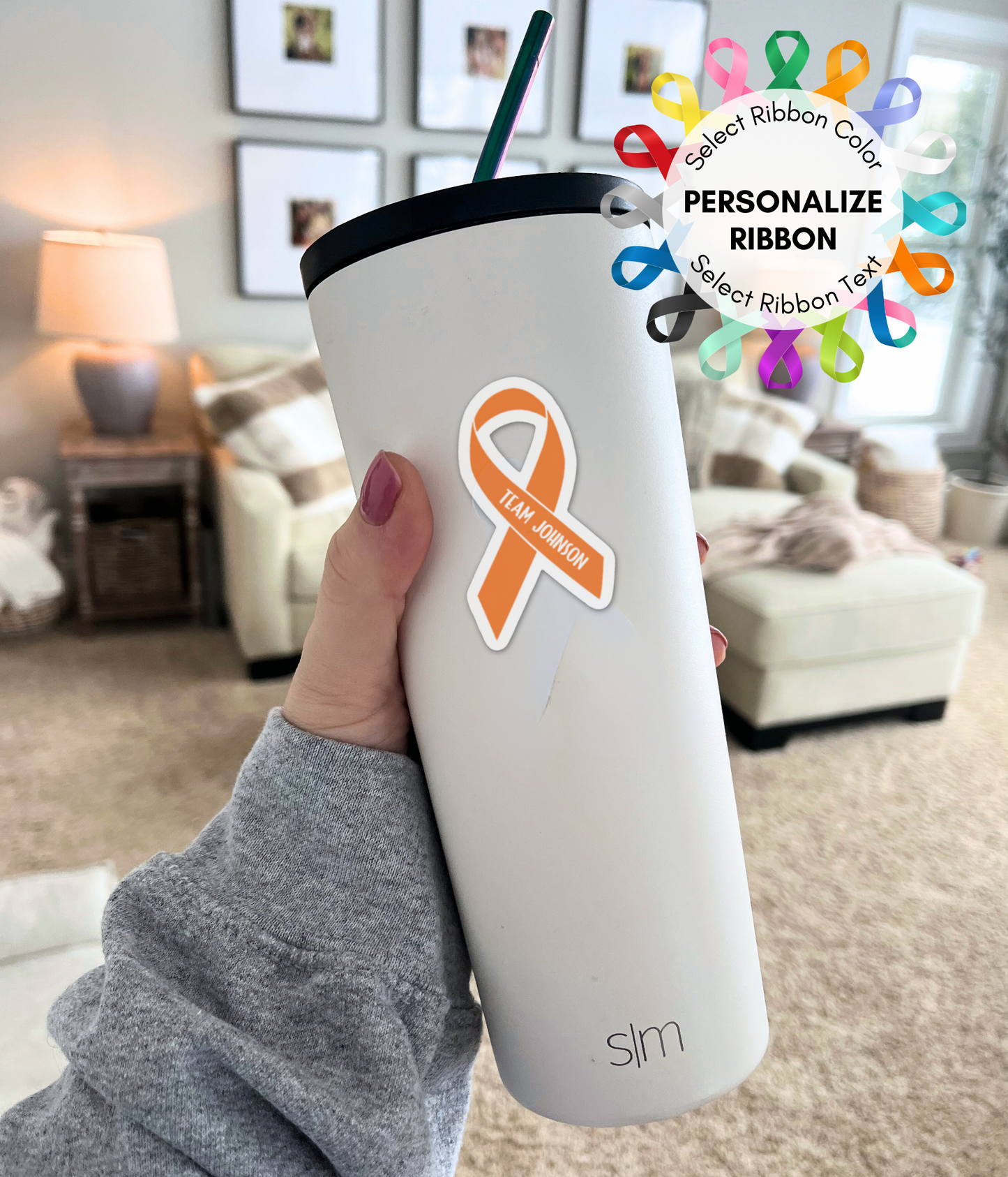 a person holding a cup with an orange ribbon on it