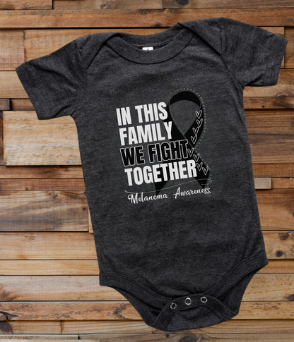 a black onesuit with a white ribbon on it that says in this family we