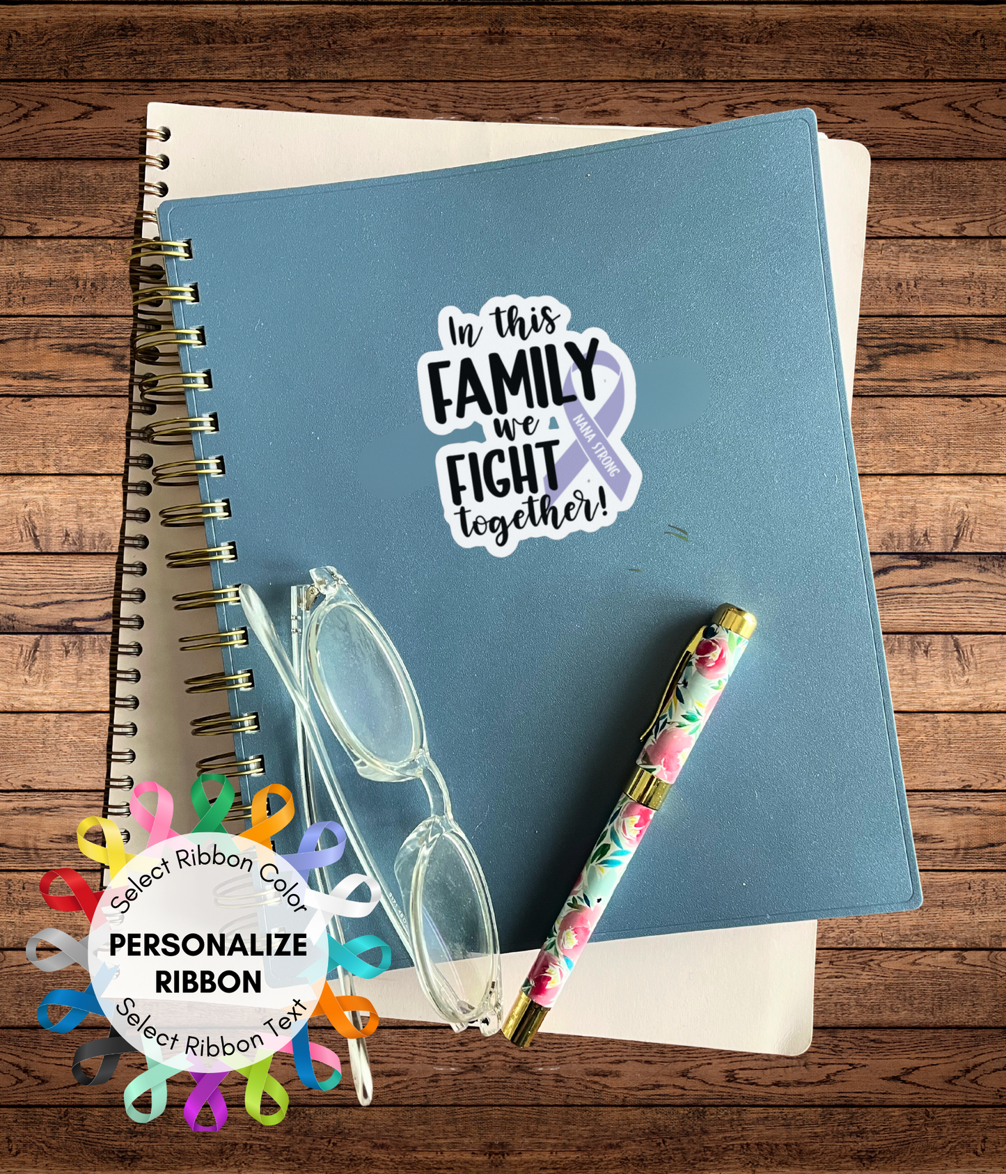 a notebook with a sticker of a family is next to a pair of glasses